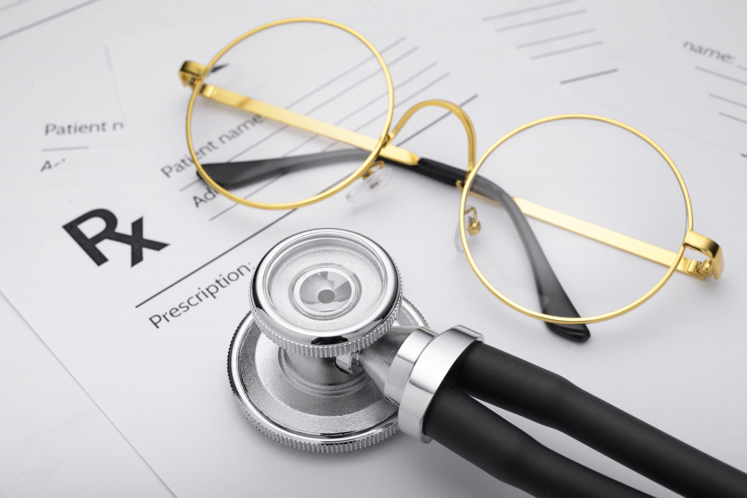 A prescription form beside a medical stethoscope